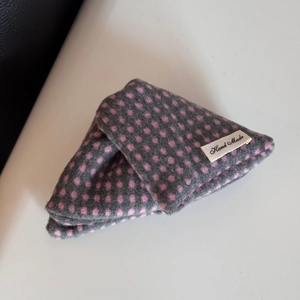 Close-up of handmade grey velvet fabric with pink polka dots and Hand Made label