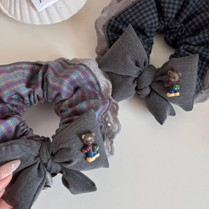 Close-up of Korean style lace scrunchies with plaid pattern and cute mini bear bows