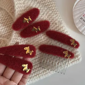 Detailed macro view of red mohair hair clips with golden horse-shaped metal charms