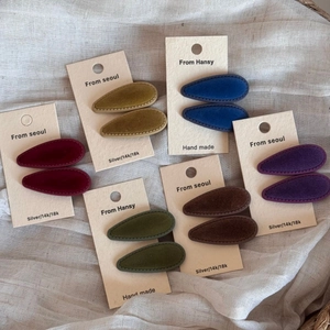 Vintage velvet teardrop hair clips in six elegant colors on white linen background