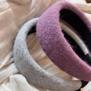 Close-up of thick wool blend headbands in purple and grey with soft fluffy texture