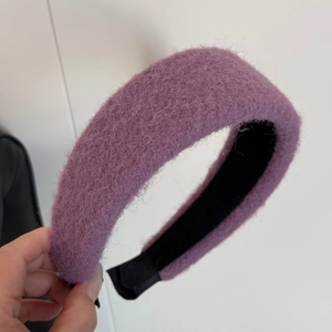 Close-up of deep purple plush headband showing thick wool-like texture and non-slip lining