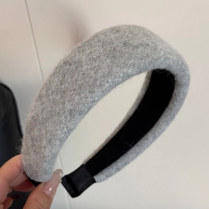 Detail of grey plush wool headband with soft thick fiber texture and non-slip inner band