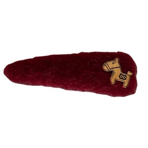 Exquisite red wool hair clip with a golden horse charm featuring heart details