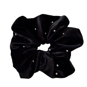 Elegant black velvet scrunchie with silver bead details for high-end hairstyling