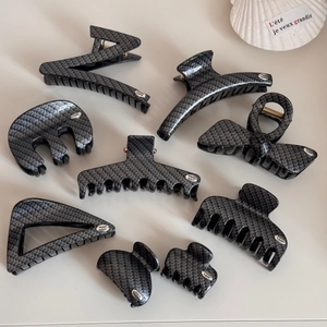 Set of carbon fiber texture hair claw clips in grey finish and various geometric shapes