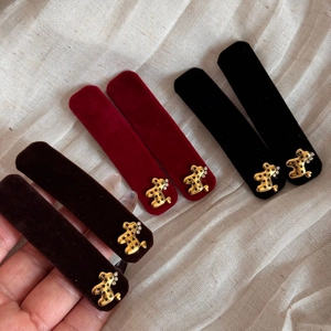 Elegant velvet hair clips with golden bear accents in dark brown, burgundy, and black