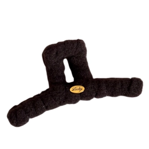 Elegant black plush hair claw clip with golden Lucky emblem for autumn winter hair styling