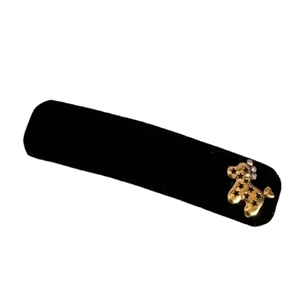 Elegant black velvet hair clip with a golden poodle charm and sparkling rhinestones