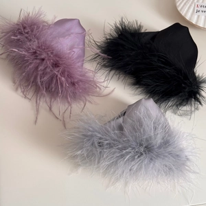Detailed close-up showing texture of luxury faux fur and satin fabric on hair claw clips