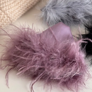 Detail of luxurious ostrich feather and satin hair claw clip in purple, grey and black