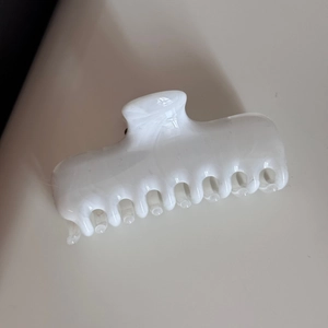 Close-up of white marble pattern shark hair clip made of premium acetate fiber material