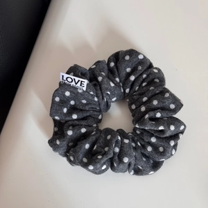 Close-up of polka dot fabric headband with a woven LOVE FROM SEOUL brand label
