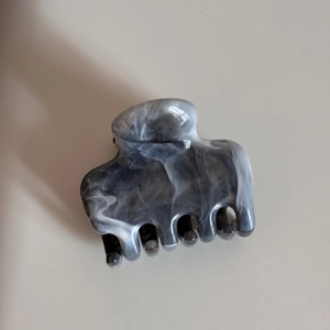 Detailed view of medium shark hair clip featuring black and white ink marble pattern