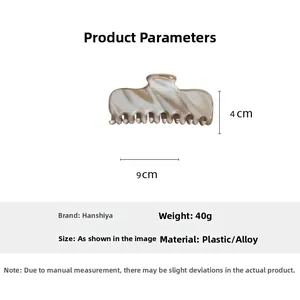 Detail view of amber acetate hair claw clip showing 9cm by 4cm product dimensions
