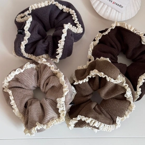 Set of four minimalist knit scrunchies with white lace edges in neutral earth tones