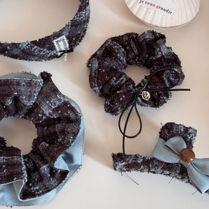 Detail of tweed hair accessories set featuring brown check pattern and pearl charms