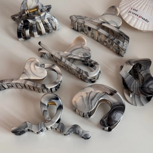 Smoky grey ink-wash marble hair claws in various geometric shapes with metal spring