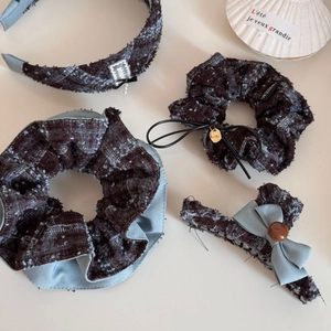 Detailed close-up of blue tweed hair accessories set including scrunchies and headbands