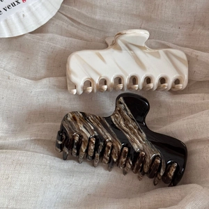 French acetate hair claw clips in marble and tortoise shell patterns for elegant styling
