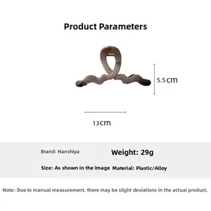 Large khaki ink pattern hair claw clip detail with 13cm length and 5.5cm height measurements
