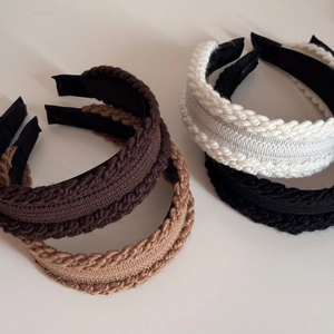 Knitted twist headbands in brown, beige, white, and black with a wide braided texture