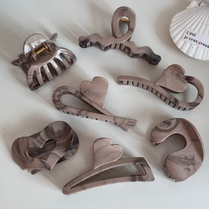 Set of seven khaki ink marble hair claws with various geometric and heart shapes