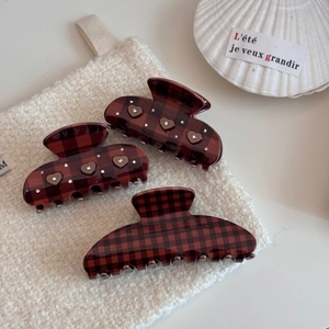Detailed set of three plaid hair claws with heart shaped accents and rhinestones