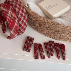 Detail of red plaid tweed hair accessories set including headbands and hair clips