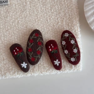 Detailed embroidery of red flowers and berries on vintage fabric hair clips set