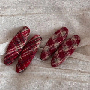 Close-up of red plaid wool hair clips with elegant classic British check pattern