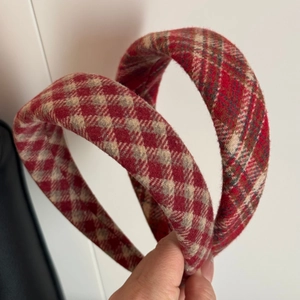 Close-up of a premium red and white plaid wool headband featuring a thick retro design