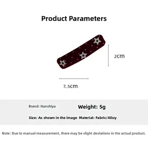 Detail view of 7.5cm burgundy velvet hair clip with white dots and sparkly star accents
