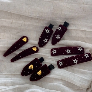 Detailed set of burgundy velvet hair clips with white polka dots and gold heart charms