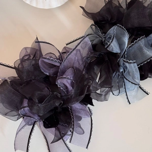 Close-up of layered organza fabric bow hair ties with delicate hemmed edge details