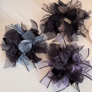 Three oversized organza scrunchies in black, blue-grey and purple with wavy edge detailing