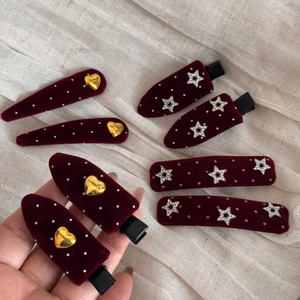 Vintage burgundy velvet hair clips with white polka dots, gold hearts, and silver stars