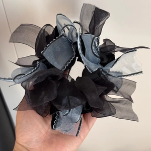Detail of multi-layered organza bow scrunchie with delicate wavy stitched edges