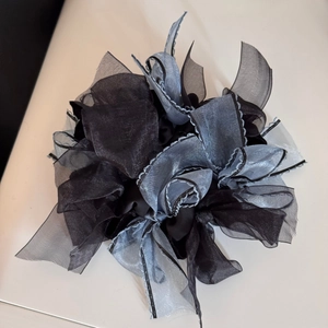Detail of multi-layered black and silver organza fabric on this oversized hair scrunchie