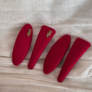 Detailed set of four red wool felt hair clips with elegant gold handmade metal accents
