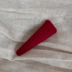 Macro detail of high-quality red wool felt fabric used for handmade hair clip accessories