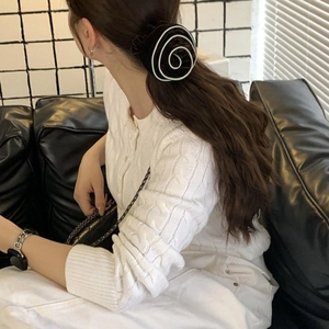 Detail of mint chocolate spiral hair scrunchie with chic monochrome striped pattern