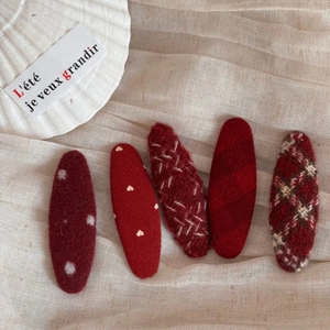 Detailed set of 5 red fabric hair clips with heart patterns and plaid textures