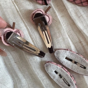 Detail of cute pink plaid fabric hair clip with durable metal BB snap and protective felt pad