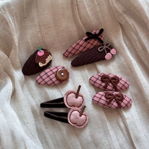 Detailed view of sweet kids hair clips set with fabric bows and cute dessert shapes