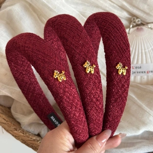 Burgundy tweed headband with gold dog ornament and star details in a French vintage style