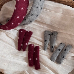 Close-up of vintage polka dot wool headbands and matching hair clips in a basket