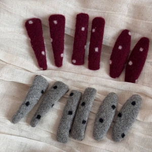 Detailed view of red and grey polka dot wool felt hair clips in various shapes