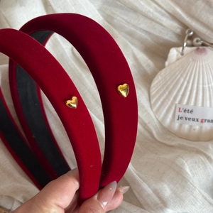 Detailed macro view of dark red velvet headband with golden heart and soft sponge padding