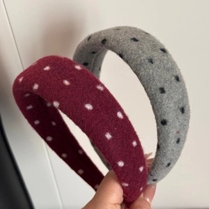 Detailed close-up of retro wool sponge headbands with polka dot pattern in red and grey